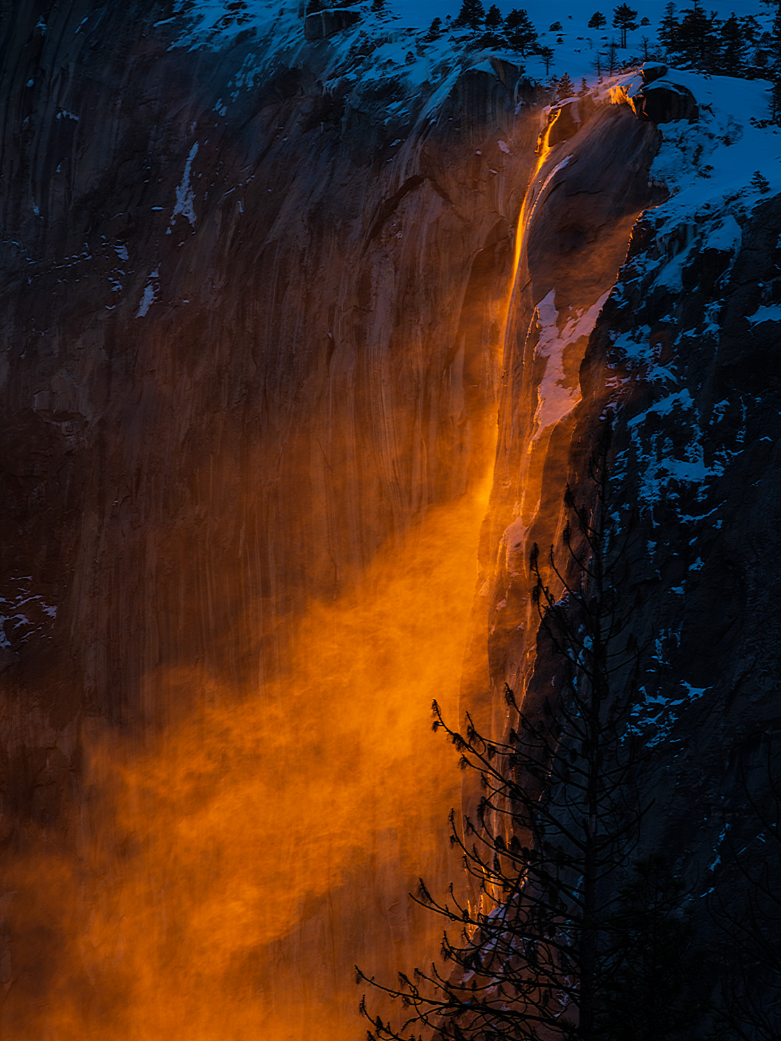 Photo of Yosemite's Firefall phenomenon as a gust of wind blows